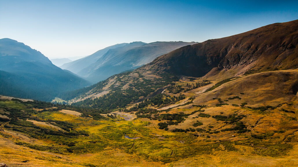 A valley around the tundra area at Rocky Mountain National Park in the morning sun.