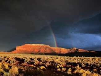 A rainbow pierces through stormy weather at Grand Staircase-Escalante National Monument, Utah.