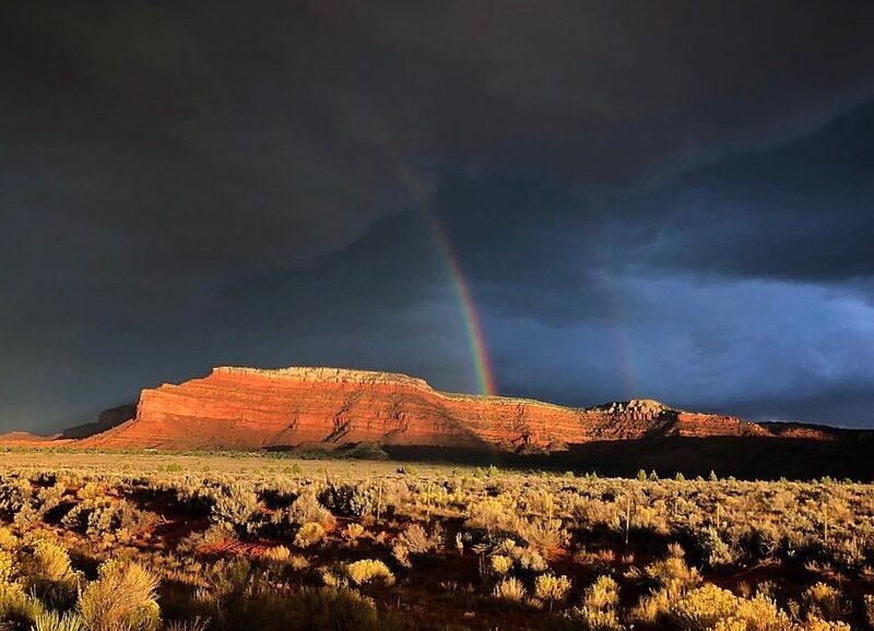 A rainbow pierces through stormy weather at Grand Staircase-Escalante National Monument, Utah.